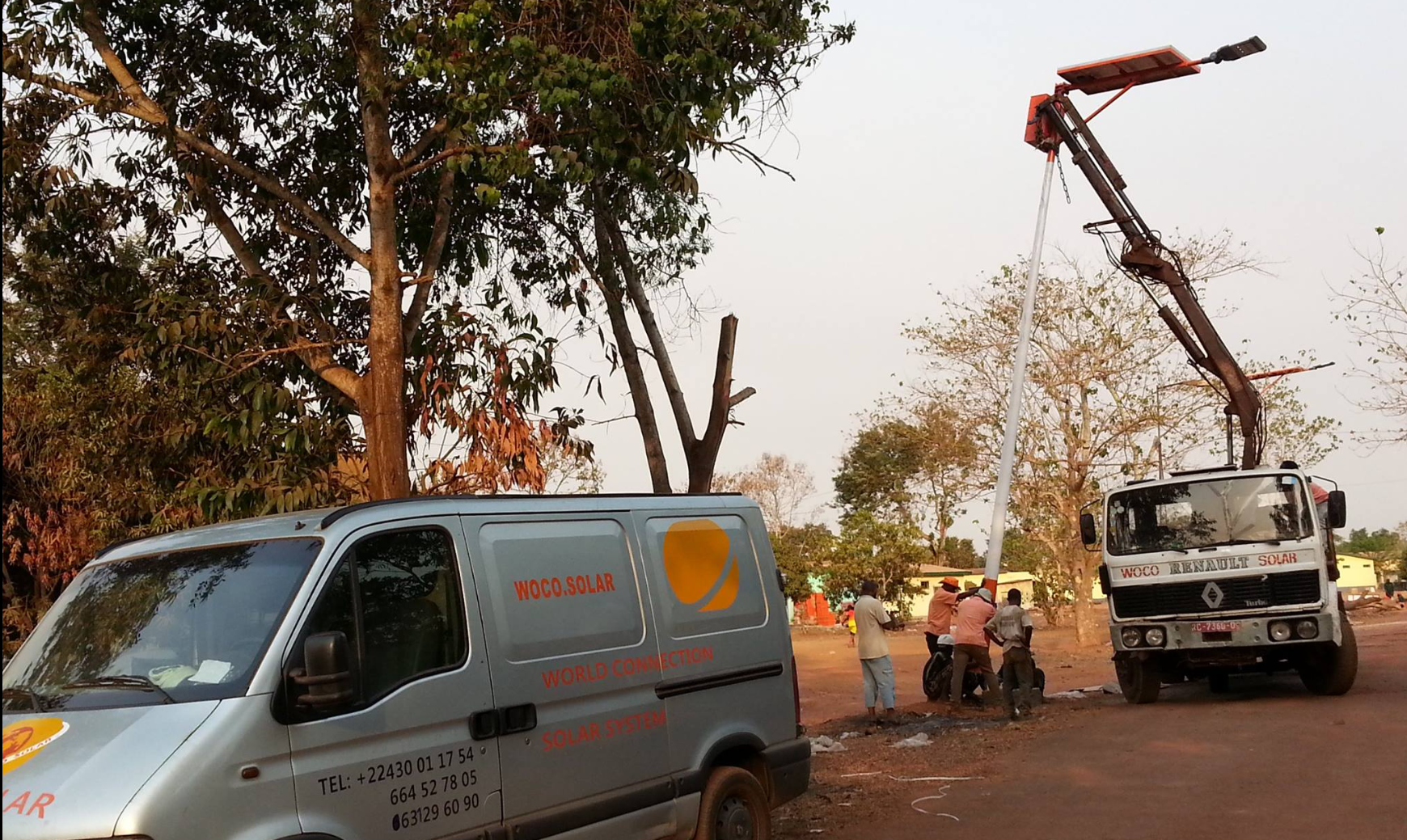 Woco Solar field operations showing branded vehicles and team working on solar installation project